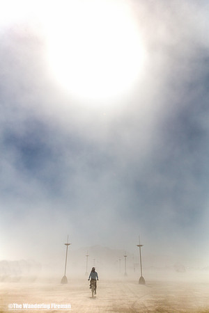 Bicycling in the dust of the playa at Burning Man in Black Rock City Nevada
