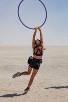 Woman swinging on a hoop at Burning Man in Black Rock City Nevada