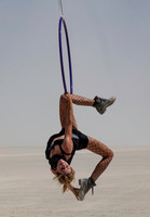 Woman hanging from a hoop at Burning Man in Black Rock City Nevada