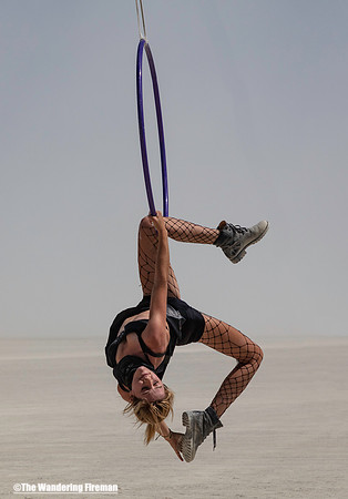 Woman hanging from a hoop at Burning Man in Black Rock City Nevada