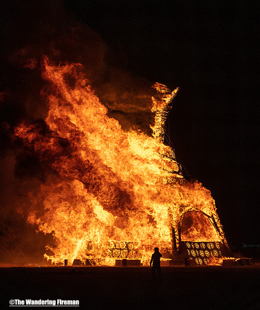 Fireman silhouetted against the Man burn.