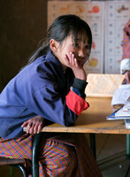 Young Bhutanese school girl sits in class