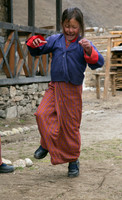 Young Bhutanese school girl playing hopscotch