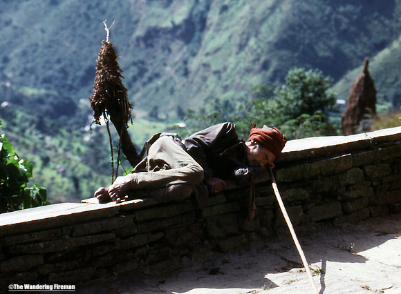 Sleeping Nepalese man on the trail