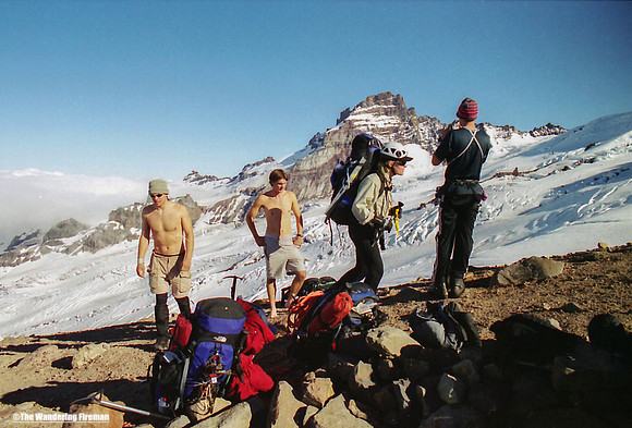 A climber passes resting climbers on Mount Ranier in Washington State