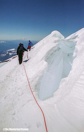 Descending past a massive crevasse on Mount Ranier in Washington State