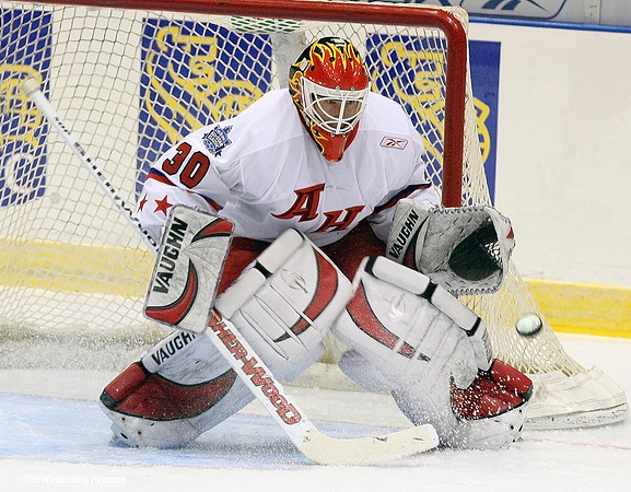 Puck flies at the goalie in ice hockey