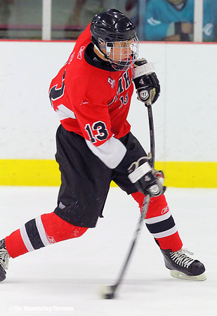 Stick bent making a slap shot in ice hockey