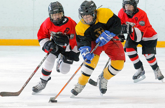Player skates the puck up the ice