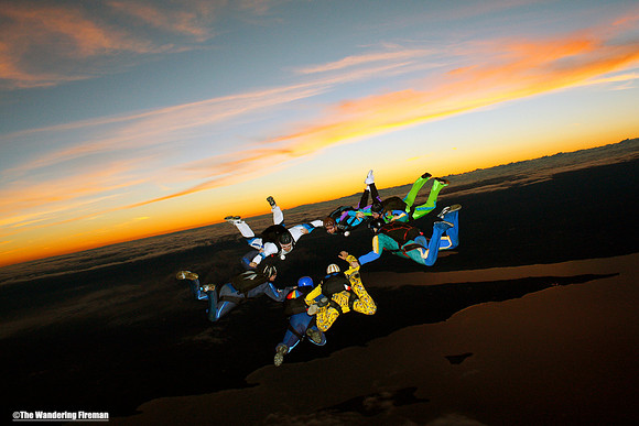 Formation skydiving at sunset