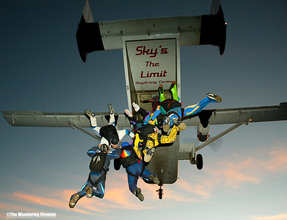 Formation skydivers exit an aircraft