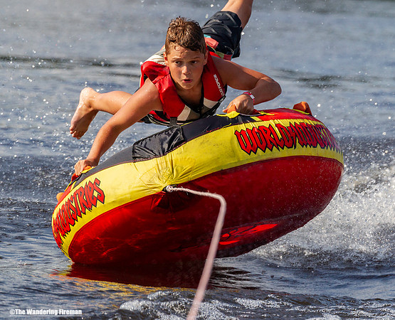 Young tube rider bounces off his tube