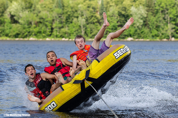 Tilting sideways on a tube being pulled behind a boat