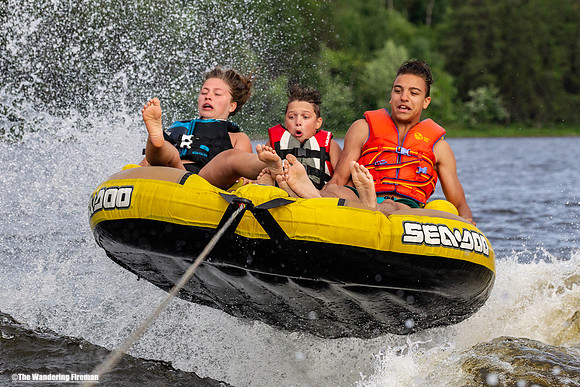 Catching air on a tube while being pulled behind a boat