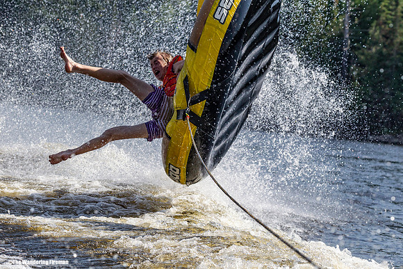 Hanging on for dear life on a tube being pulled behind a boat