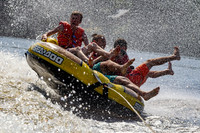 Tubing fun mania being pulled behind a boat