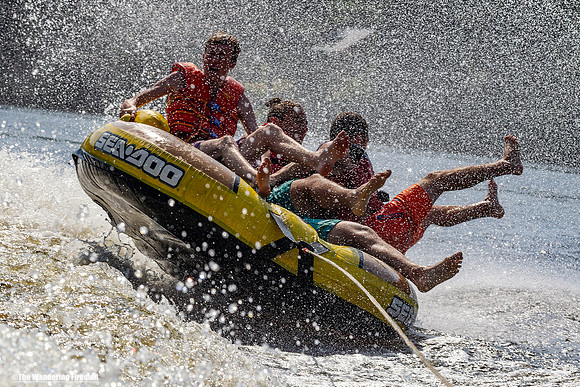 Tubing fun mania being pulled behind a boat