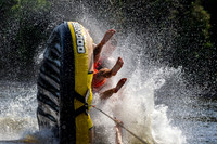 A foam spray and a tube being pulled behind a boat