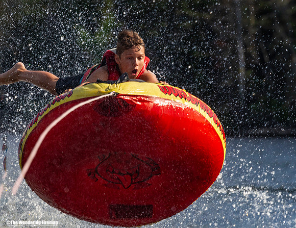 Young tube rider flies off his tube