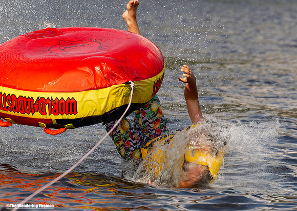 Solo tube rider flips his tube upside down