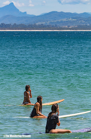 Three surfers in Byron Bay