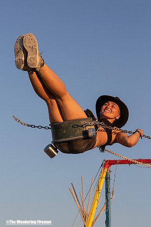 Swinging on a swing set at Burning Man