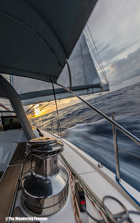 The Aranui yacht heels over at sunset on the Pacific Ocean