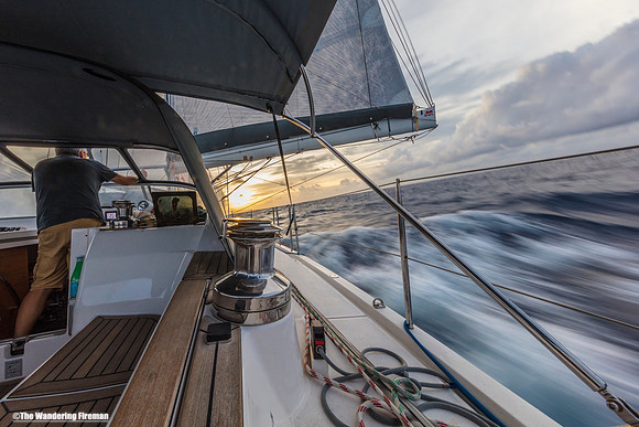 The Aranui yacht heels over at sunset on the Pacific