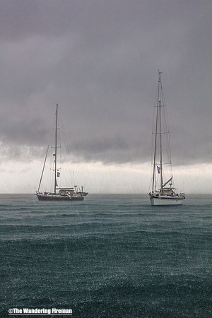 Two yachts in the harbour rainstorm in Puerto Ayora of the Galapagos Islands