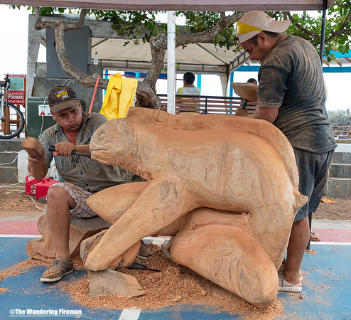 Wood carvers in Puerto Aroyo, Galapagos Islands