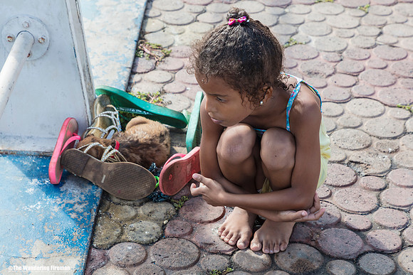 Young girl and puppy in Puerto Aroyo