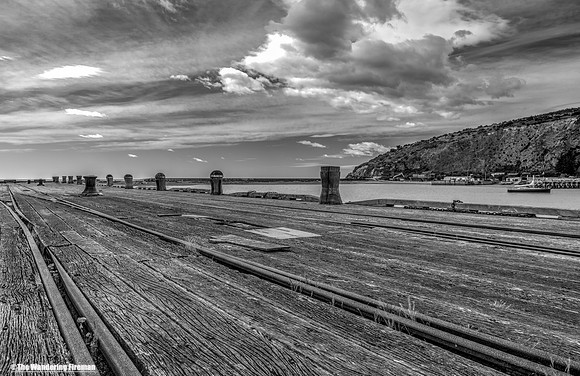 A monochrome image of a dockside on the south island of New Zealand