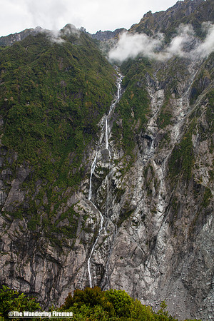 Waterfall in Franz Josef glacier valley of New Zealand