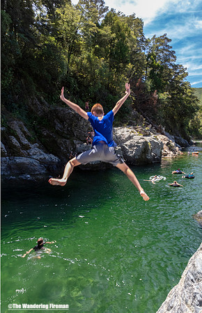 Young teen jumps into the Pelorus river in New Zealand