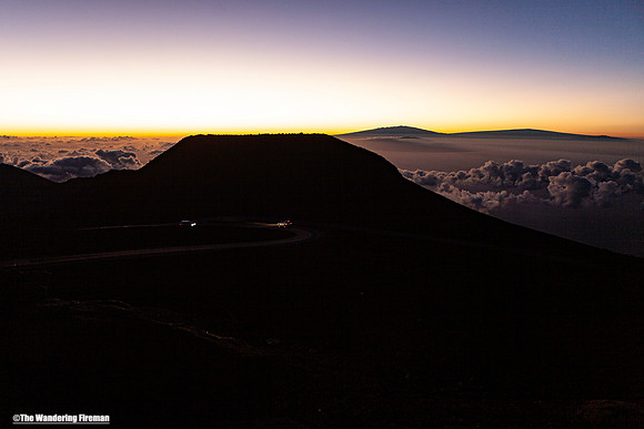 Haleakala sunrise and two vehicles on Maui Hawaii