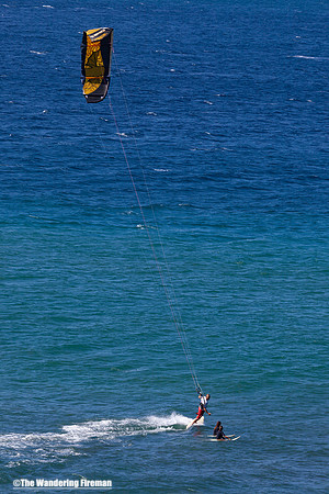 Kite surfer and board surfers in Maui Hawaii