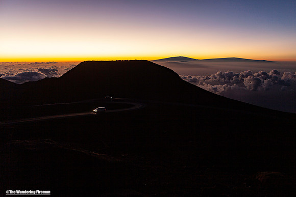 Two vehicles approach in the morning on Haleakala Maui Hawaii