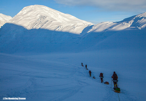 A rope team pulls their sleds on the glacier of Denali, Alaska, the highest mountain in North America
