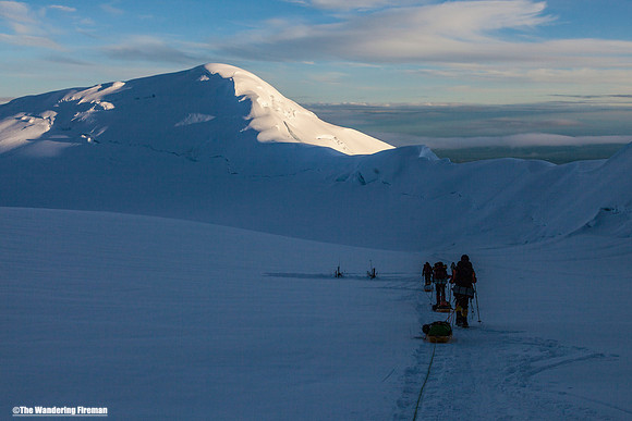 A rope team slogs along the glacier on Denali, Alaska, the highest mountain in North America
