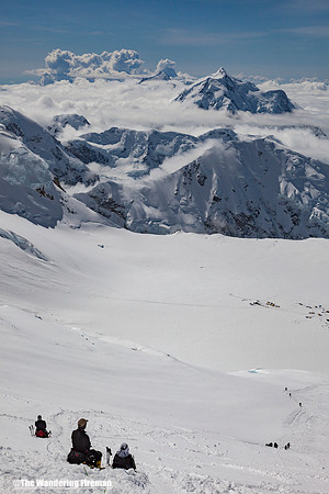 Climbers rest on the fixed lines looking down at 14,000' camp on Denali, Alaska, the highest mountain in North America