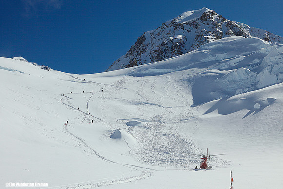 Helicopter lands on Motorcycle Hill on Denali, Alaska, the highest mountain in North America
