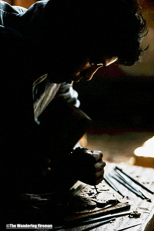 A wood carver in Chitwan National park Nepal plies his trade