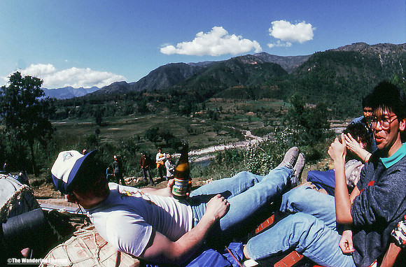 Having a beer while riding atop the bus to Pohkara Nepal