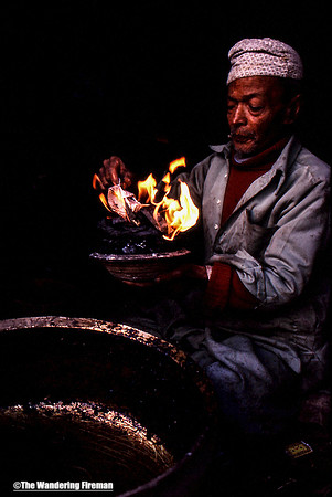 Nepalese craftsman with fire