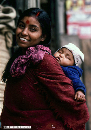 Smiling happy mother with baby in Nepal