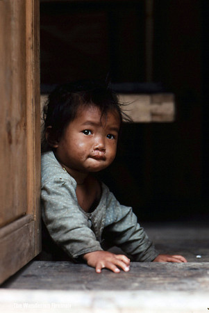 Very young child in a doorway in Kathmandu Nepal