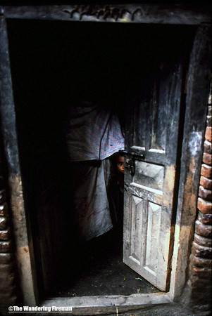 Young boy and mother in a Kathmandu Nepal doorway