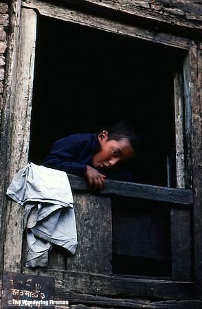 Young boy in a window in Kathmandu, Nepal