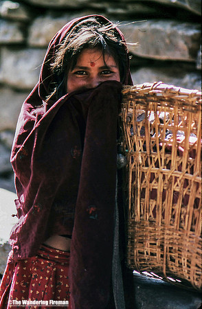 Young girl smiling holding a basket in Nepal