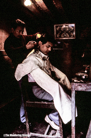 Man getting his hair cut in a Kathmandu Nepal barber shop